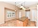 Bright kitchen with an island, neutral countertops, tile floors, and modern lighting fixtures at 5300 Breakers Way, Carmel, IN 46033
