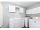 Bright laundry room with storage cabinets, modern washer and dryer, and plenty of counter space at 5300 Breakers Way, Carmel, IN 46033