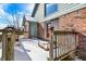 Winter back deck with wooden railing, connected to the house with brick and vinyl siding at 60 Huddleston N Dr, Indianapolis, IN 46217
