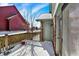 Home's deck with a light green door amidst a snow covered landscape at 60 Huddleston N Dr, Indianapolis, IN 46217