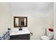 Bathroom with a white countertop vanity and dark wood framed mirror at 60 Huddleston N Dr, Indianapolis, IN 46217
