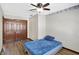 A charming bedroom offers a ceiling fan, wood-look floors, and a closet at 60 Huddleston N Dr, Indianapolis, IN 46217