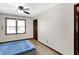 A bedroom with a window offers wood-look floors and a closet at 60 Huddleston N Dr, Indianapolis, IN 46217