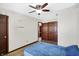 A simple bedroom offers a ceiling fan, wood-look floors, and a closet at 60 Huddleston N Dr, Indianapolis, IN 46217