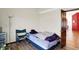 Bedroom with wood laminate flooring, an open door, and minimal furnishings at 60 Huddleston N Dr, Indianapolis, IN 46217
