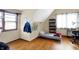 Angled bedroom includes two windows, bookshelves and a wood floor at 60 Huddleston N Dr, Indianapolis, IN 46217