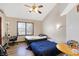 Bedroom with wood laminate flooring, two twin beds and a ceiling fan at 60 Huddleston N Dr, Indianapolis, IN 46217