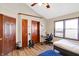 Bedroom with wood laminate flooring, a desk, and a guitar stand at 60 Huddleston N Dr, Indianapolis, IN 46217
