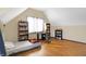 Angled bedroom includes one window, bookshelves and a wood floor at 60 Huddleston N Dr, Indianapolis, IN 46217