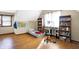Cozy bedroom featuring hardwood floors, a sloped ceiling, and built-in bookcases at 60 Huddleston N Dr, Indianapolis, IN 46217