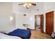 Bedroom with wood laminate flooring, two twin beds and a view to a hallway at 60 Huddleston N Dr, Indianapolis, IN 46217