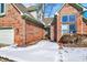 Inviting brick home entrance, surrounded by winter's snowy embrace at 60 Huddleston N Dr, Indianapolis, IN 46217