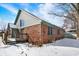 Back exterior of a brick home with green trim in winter snow at 60 Huddleston N Dr, Indianapolis, IN 46217