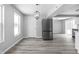 Bright dining area features new floors, modern lighting, and stainless steel refrigerator at 6205 Beech Grove Rd, Martinsville, IN 46151