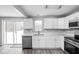 Modern white kitchen with stainless steel appliances and plenty of counter space at 6205 Beech Grove Rd, Martinsville, IN 46151