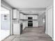 Well-lit kitchen with white cabinets, stainless appliances, and modern gray flooring at 6205 Beech Grove Rd, Martinsville, IN 46151