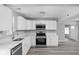 Bright kitchen features white cabinets, stainless steel appliances, and modern fixtures at 6205 Beech Grove Rd, Martinsville, IN 46151