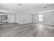 Spacious living room featuring new flooring, and freshly painted light grey walls at 6205 Beech Grove Rd, Martinsville, IN 46151