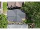 An overhead view of a home with a dark roof, surrounded by green trees and neighboring houses at 633 E 32Nd St, Indianapolis, IN 46205