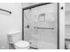 Modern bathroom featuring a toilet, a walk-in shower with marble tile surround, and built in shelving at 633 E 32Nd St, Indianapolis, IN 46205
