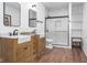 Modern bathroom featuring double sinks, wood cabinets, a walk-in shower, and a white marble tile surround at 633 E 32Nd St, Indianapolis, IN 46205