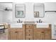 Modern bathroom featuring double sinks with bronze fixtures, wood cabinets, and a white marble countertop at 633 E 32Nd St, Indianapolis, IN 46205