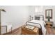 Cozy bedroom with wood floors, a black metal bed frame, and tasteful decor at 633 E 32Nd St, Indianapolis, IN 46205