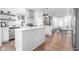 Open concept kitchen with kitchen island flows to living room with stainless appliances and white cabinets at 633 E 32Nd St, Indianapolis, IN 46205
