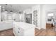 Bright, open kitchen featuring white cabinets, a quartz island, stainless appliances, and hardwood floors at 633 E 32Nd St, Indianapolis, IN 46205