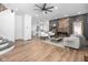 Open-concept living area features hardwood floors, modern furnishings, and exposed brick accent wall at 633 E 32Nd St, Indianapolis, IN 46205
