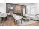 Bright living room features hardwood floors, modern white sofa, exposed brick wall, and a stylish decor at 633 E 32Nd St, Indianapolis, IN 46205