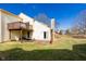 Backyard of home featuring a deck, brick patio, stone chimney, and a lawn, perfect for outdoor relaxation at 6348 Bay Vista E Dr, Indianapolis, IN 46250