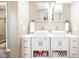Bathroom with double sinks, white cabinets, and modern fixtures at 6348 Bay Vista E Dr, Indianapolis, IN 46250