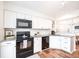 Well-lit kitchen with white cabinets, granite countertops, and stainless steel appliances at 6348 Bay Vista E Dr, Indianapolis, IN 46250