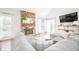 Cozy living room with a stone fireplace, a plush sectional sofa, and natural light from sliding doors at 6348 Bay Vista E Dr, Indianapolis, IN 46250