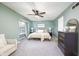 Relaxing main bedroom with neutral carpet, ceiling fan, and large window providing natural light at 6348 Bay Vista E Dr, Indianapolis, IN 46250