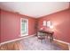 Home office featuring a sleek desk setup, accent wall, natural light, and hardwood floors at 6348 Bay Vista E Dr, Indianapolis, IN 46250