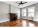 Light filled living room featuring hardwood floors and a brick fireplace at 643 Fort Wayne Ave # B & D, Indianapolis, IN 46204
