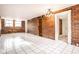 Open living room featuring exposed brick, white tile floors, and modern lighting at 643 Fort Wayne Ave # B & D, Indianapolis, IN 46204