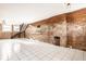 Large living room with a staircase and exposed brick walls at 643 Fort Wayne Ave # B & D, Indianapolis, IN 46204