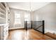 Bright living room with hardwood floors, chandelier, and staircase at 643 Fort Wayne Ave # B & D, Indianapolis, IN 46204