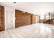Open living room with exposed brick, white tile floors, and modern lighting at 643 Fort Wayne Ave # B & D, Indianapolis, IN 46204