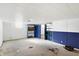 Unfinished basement area with concrete floor and blue accent wall at 6838 Hague Rd, Indianapolis, IN 46256