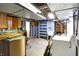 Basement includes washer/dryer hookups, potential workspace, and storage options at 6838 Hague Rd, Indianapolis, IN 46256