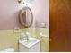 Bathroom with mirror, sink, yellow tile and pink walls at 6838 Hague Rd, Indianapolis, IN 46256