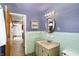 Bathroom with green tiling, sink, mirror, and toilet at 6838 Hague Rd, Indianapolis, IN 46256