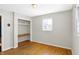 Bedroom with hardwood floors, closet, window and open shelving at 6838 Hague Rd, Indianapolis, IN 46256