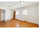 Bedroom with two windows, hardwood floors, closet, and ceiling lights at 6838 Hague Rd, Indianapolis, IN 46256