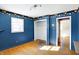 Bedroom has blue walls, hardwood floors, and closet at 6838 Hague Rd, Indianapolis, IN 46256
