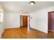 Bedroom with closet and two doorways, ceiling light, and hardwood floor at 6838 Hague Rd, Indianapolis, IN 46256